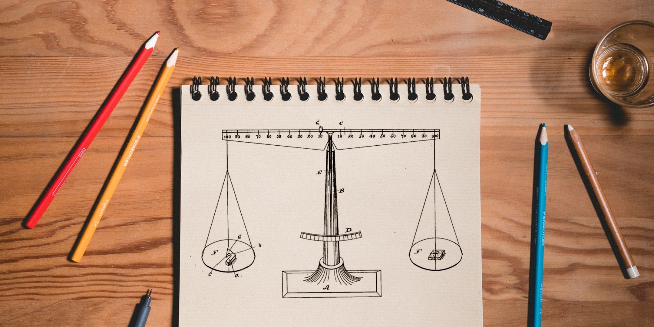 Drawing of a scale with pencils surrounding it