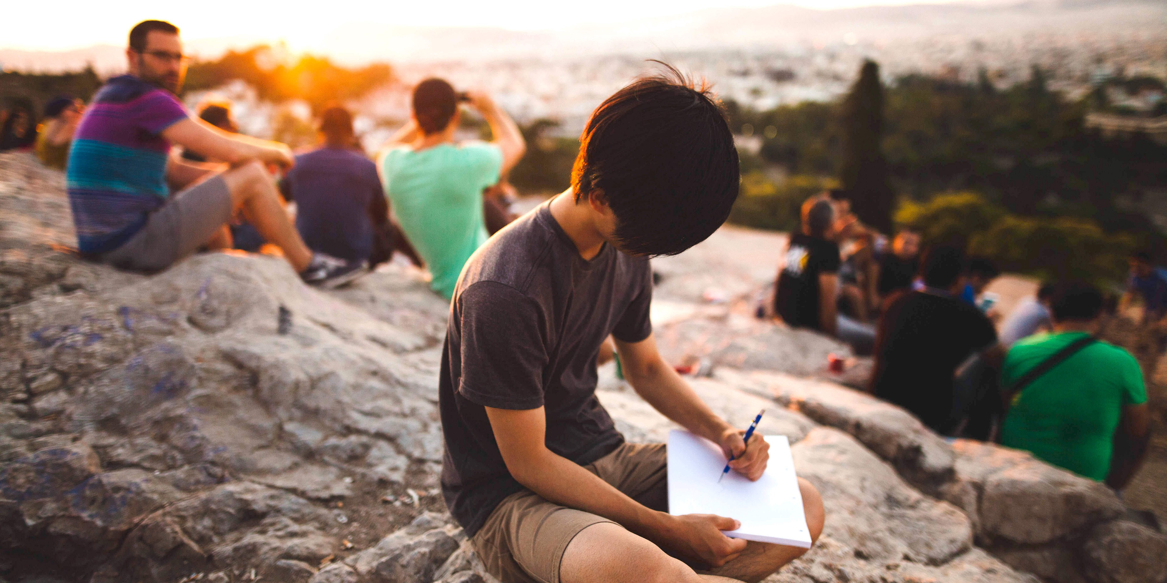 Photo of a kid writing on the beach